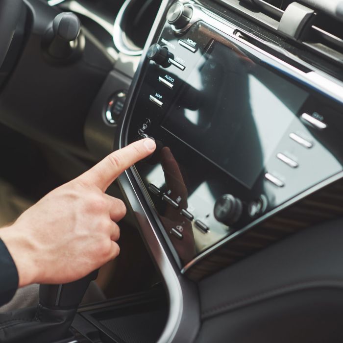 Man includes an audio system in the car.