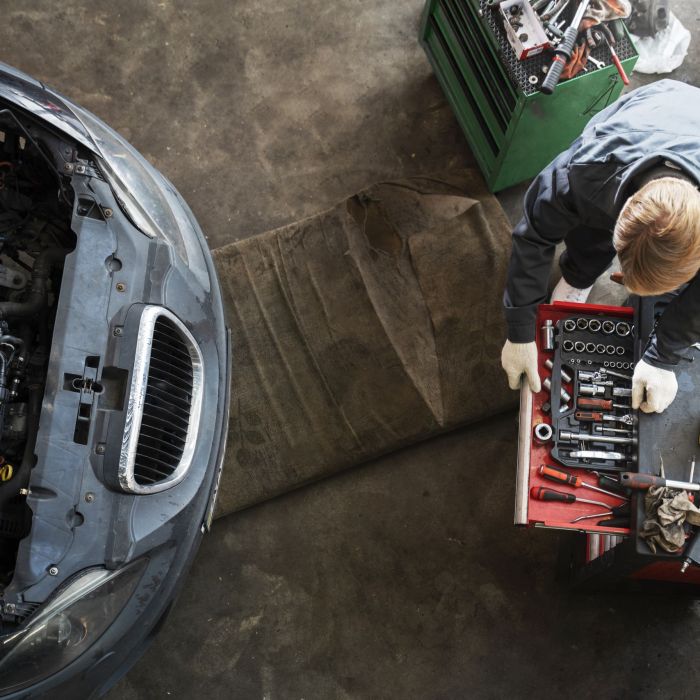 top-view-man-repairing-car