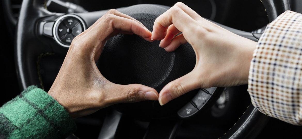 young-couple-traveling-with-car-close-up-doing-heart-shape