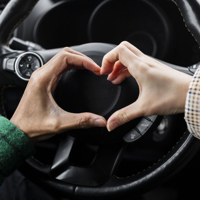 young-couple-traveling-with-car-close-up-doing-heart-shape