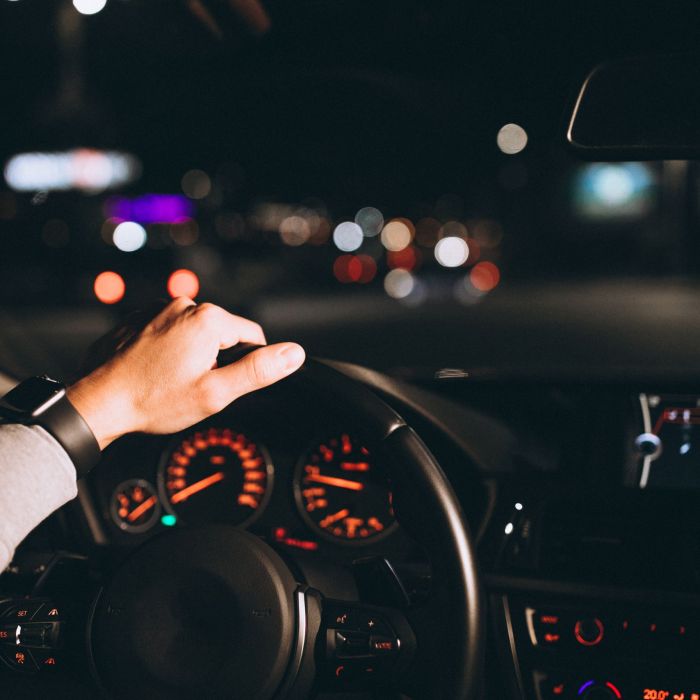 Young man driving his car at a night time